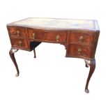 A Georgian style mahogany serpentine fronted desk, the moulded top set with tooled leather skiver,