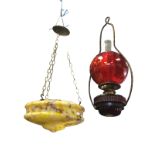 A yellow/amber mottled glass plaffonier of inverted bowl shape suspended by brass chains; and a ruby