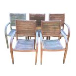 A set of five teak garden armchairs with slatted backs and seats, having curved downswept arms on