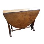 A Victorian walnut sutherland table with two rounded drop leaves to form an oval moulded top,