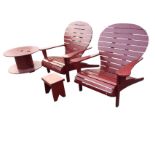 A painted garden set with a pair of slatted chairs having spade shaped backs and platform arms, with