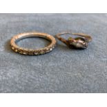An eternity ring, the stones claw set on a silver coloured band - repaired; and another ring set