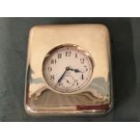 A late Victorian silver cased travelling timepiece, the plated clock with Swiss movement under
