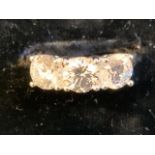 A sterling silver three stone zirconia ring, the claw set brilliant cut Swarovski stones raised in a
