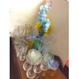 A collection of glass vases, some coloured and with faux flowers, bowls, sets of drinking glasses,