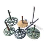 A set of three cast iron parasol bases with circular pierced scrolled stands; two other cast iron