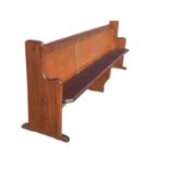 A rectangular mahogany pew, the panelled back with hymnbook shelf above a solid chamfered seat,