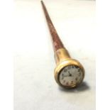 A tapering rosewood walking cane mounted with brass collar and cased watch with dial under convex