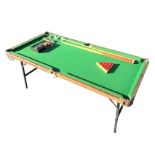 An Amfax snooker table on folding metal legs, complete with queues, balls, leather pocket covers,