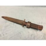 A WW1 German fighting knife, the tapering steel blade having ribbed hardwood handle, the metal