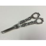 A pair of Victorian silver grape scissors with pierced vine embossed handles and tapering pincer