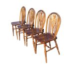 A set of four wheelback dining chairs with hoops on spindles framing pierced splats, the solid seats