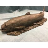 A bronzed terracotta salmon, the fish modelled on naturalistic ground - stamped monogram. (20.25in)