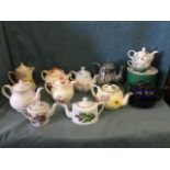 A collection of teapots including pairs of handpainted Falcon Ware and by Woods, silver lustre,