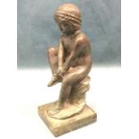 Bronze, patinated figure of a seated young girl with leaf band to hair, the figure tightening her