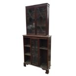 A stained mahogany bookcase, the top with astragal glazed doors enclosing shelves, the base with