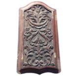 An arched Victorian carved mahogany panel with acanthus scrolled swagged decoration on pounced