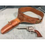 A replica Colt .45 single action army revolver, with a western style leather holster, dummy bullets,