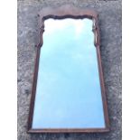 A George II style rectangular walnut mirror, the top with shaped panel above a moulded scalloped