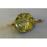 A green quartz single stone ring, the gem raised in a solitaire claw setting, on a fine gold