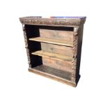 A Victorian carved oak bookcase with rectangular top above a chisel carved apron with roundels,