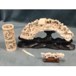 A twentieth century ivory tusk, carved in miniature with figural scene with boats, buildings,