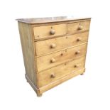A Victorian pine chest of drawers with rectangular rounded top above two short and three long