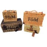Four woven cane hampers, two Fortnum and Mason, with leather straps and carrying handles. (4)