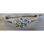 A sterling silver and Swarovski zircon ring, the nine stones set in a diamond shaped panel, on a