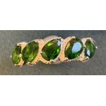 A Russian diopside ring, the five pear shaped green stones claw set above a silver band - 925