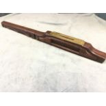 An early nineteenth century brass level with red walnut case, having detachable moulded handle