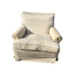 An upholstered armchair with loose covers and cushion, the rectangular back above a sprung seat,
