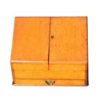 A late Victorian oak stationary cabinet with angled hinged doors enclosing an interior with