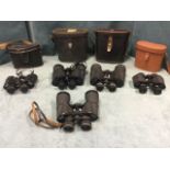 A leather cased set of Regentlux 7 x 50 binoculars with compass to lid; a similar Super Zenith set