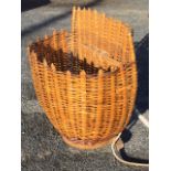A cane grape-pickers basket of D-shaped outline mounted with leather shoulder straps. (23in)