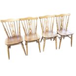 A set of four Polish teak Dinette dining chairs with pierced splats framed by spindles above wide