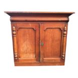 A Victorian ash press cupboard, with angled cornice above a half column frieze, the arched