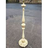 A carved, painted and gilded standard lamp, the fluted column above a twisted support, raised on