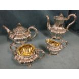 A George III four-piece silver teaset with bulbous lobbed bodies and acanthus leaf handles raised on