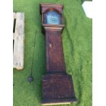 An eighteenth century oak longcase clock, the hood with caddy top above an arched glazed door