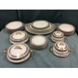 A Limoges dinner service decorated with blue bands and urn floral panels framed by chevron lines -
