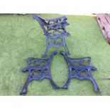 Two pairs of cast iron bench ends with scrolled decoration to chanelled frames, having scrolled arms