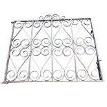 A wrought iron garden gate with four scroll decorated panels in rectangular frame. (42in x 33in)