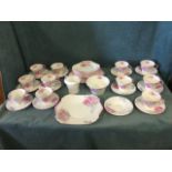 A Shelley 12-piece deco shaped teaset handpainted with pink flowers on grey ground complete with