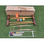 A cased croquet set with instructions, mallets, balls, hoops, posts, etc. (42in x 11.5in x 9in)