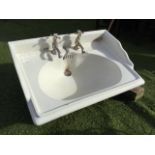 A large Delta washbasin, with integral scalloped moulded soap dishes, and Grosvenor taps with plug &