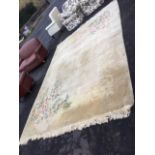 A Chinese thick pile wool carpet woven with embossed ivory floral frieze on mushroom ground, with