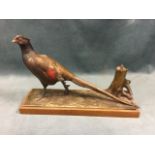 An Austrian cold painted spelter lighter modelled as a cock pheasant by treestump, mounted on