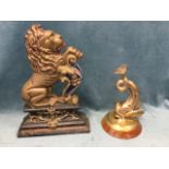A Victorian cast iron doorstop modelled as a rearing lion resting on shield, supported on scroll