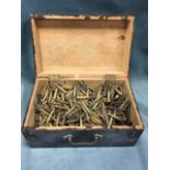 An old painted wood box full of brass spent bullet cases, the dovetailed box with brass handle. (